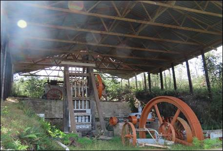 A large metal wheel in a shed